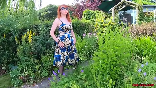 Busty babe Red XXX fingers herself in the garden