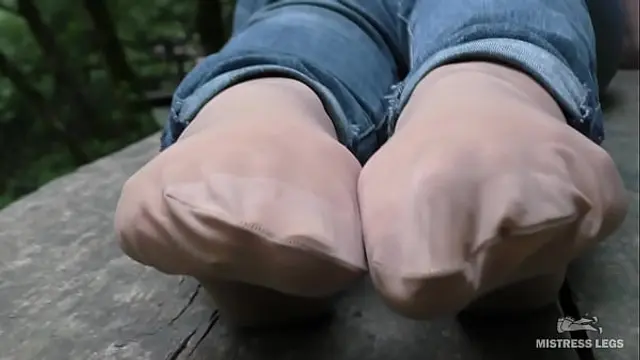 Jeans Feet In Nylon Socks In The Forest